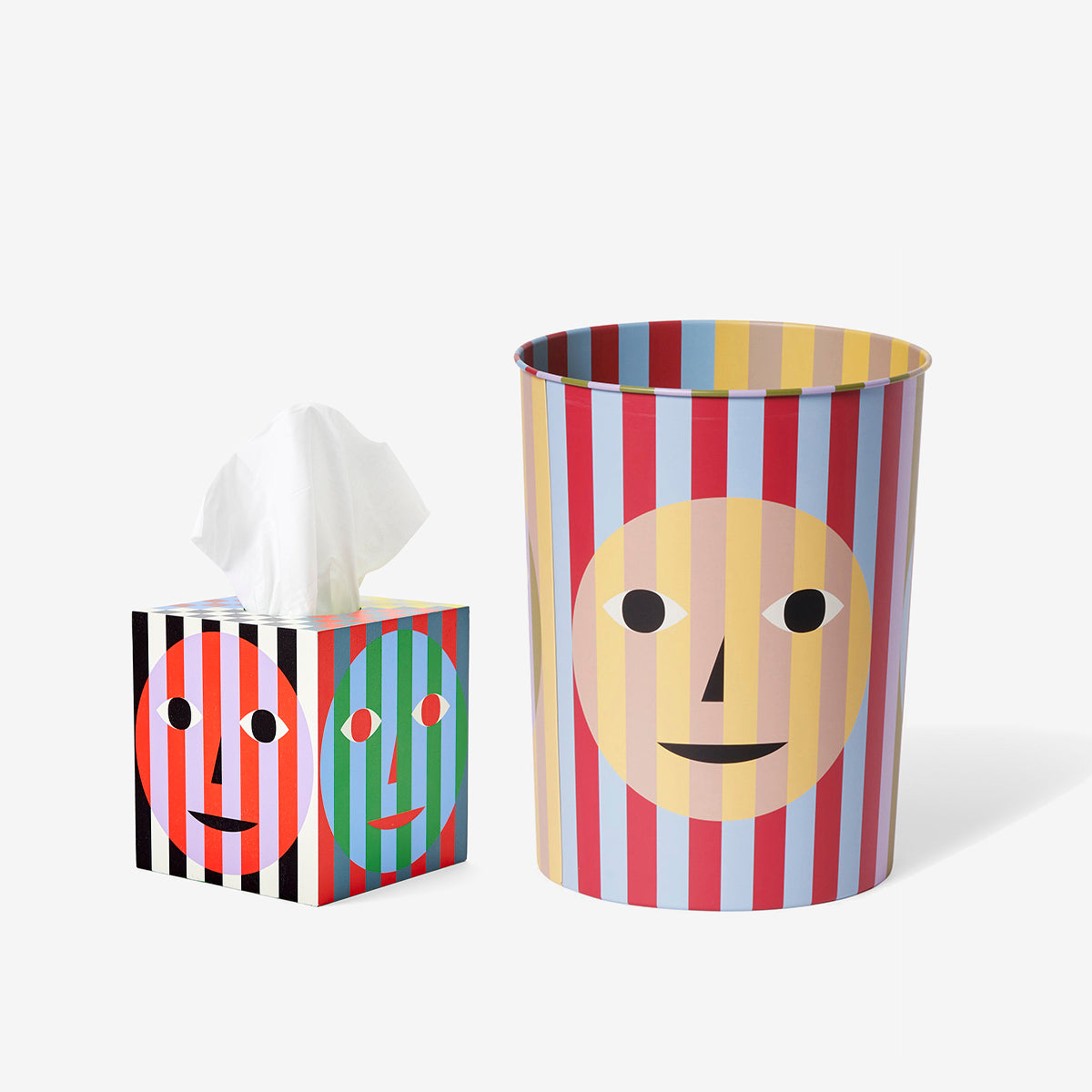 A colorful trash can and tissue box, both with playful striped designs and smiling face patterns.